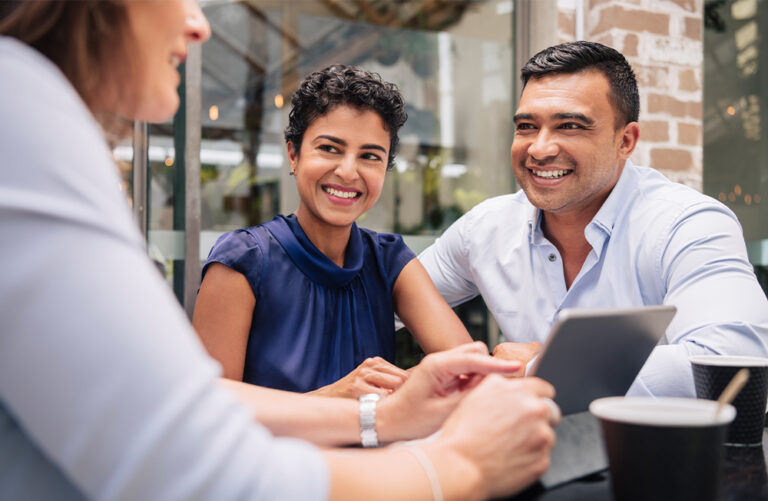 hispanic couple meeting with financial advisor